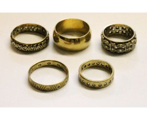 9ct gold band ring and four eternity rings, some 9ct and silver.