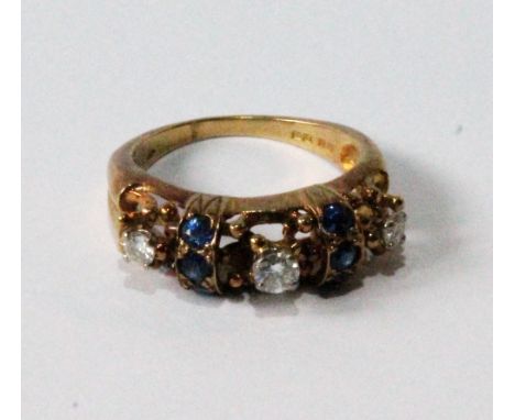 Unusual half-hoop ring with three diamond brilliants and six sapphires set together in threes, in gold beaded openwork, 1974.