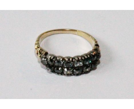 Georgian diamond ring with two rows of seven old-cut brilliants in gold fronted with silver, the shoulders pierced with carve