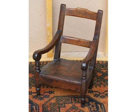 Victorian oak child's or doll's armchair with scroll arms and turned legs, 47cm high.