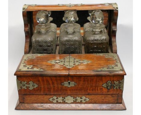 Victorian plate-mounted oak tantalus with three square, hobnail-cut glass decanters, 31cm high. Condition Report Inscription 