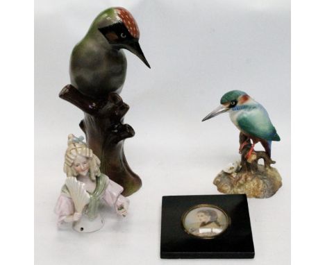 Royal Crown Derby figure of a kingfisher, 14cm high, a figure of a woodpecker, 25cm high, a tea cosy porcelain lady, 11cm hig