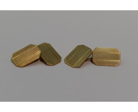 A pair of 9ct gold cufflinks of canted oblong form having engine turned striped decoration and chain connectors