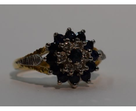 A lady's dress ring having a sapphire and diamond triple cluster to open raised shoulders on an 18ct gold loop, size O