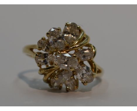 A lady's dress ring having a ten stone cubic zirconia open cluster in a stylised mount on a 14ct gold loop, size T