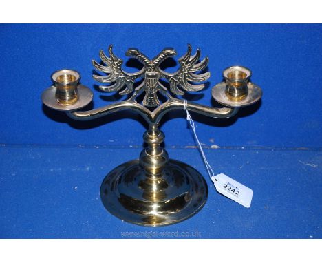 A brass double headed Eagle Candlestick. 8 1/2" tall.