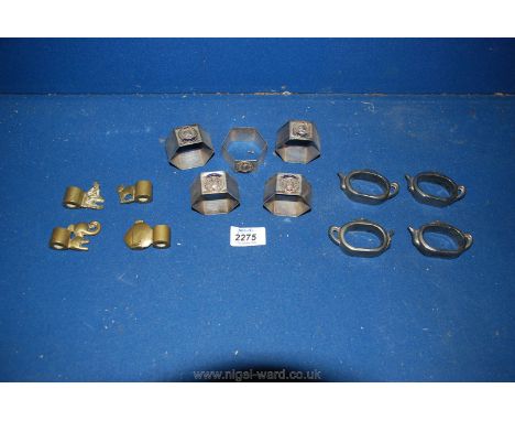 A quantity of Queen Elizabeth II napkin rings, teapot napkin rings and brass menu holders.