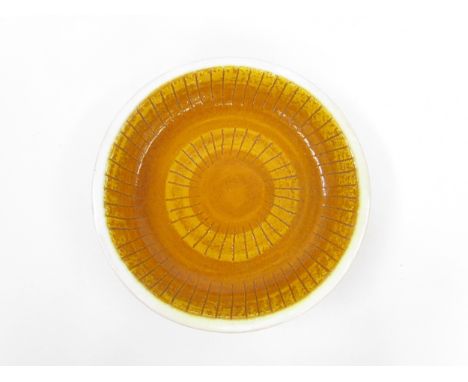 An Italian Bitossi style bowl, mustard glaze with indistinct 'Italy' marks to base. 23.5cm diameter x 5cm high 