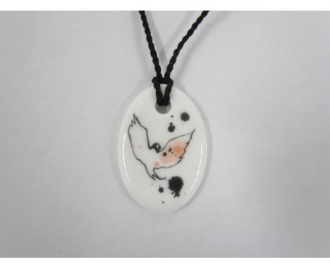 A Louisa Burfitt Swedish ceramic pendant by Rorstrand Pottery, titled Mademoiselle Oiseu verso. 4.5cm 