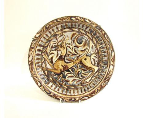 A Porches Pottery studio ceramic wall charger, hand painted with stylised dear and foliate. Painted marks verso. 39.5cm diame