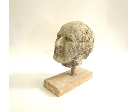 A ceramic hand worked studio sculpture of a mans head, set on a wooden plinth base. 31cm high 