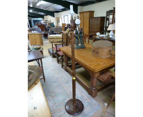 A carved oak standard lamp