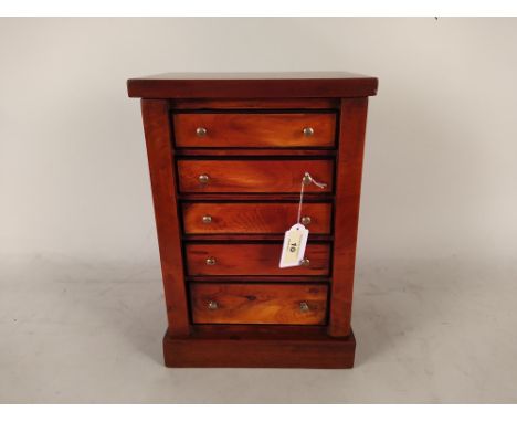 A miniature chest of five drawers with mahogany veneer and ebony stringing, 13 1/4" high
