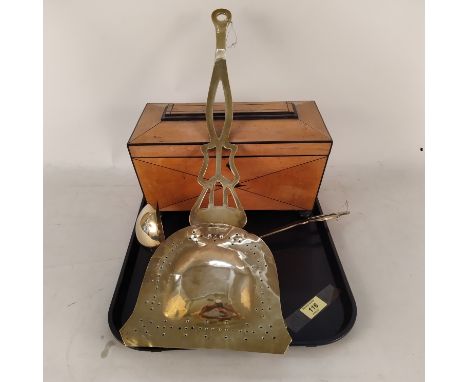 An antique satinwood tea caddy with void interior plus a Victorian brass chestnut roaster and ladle