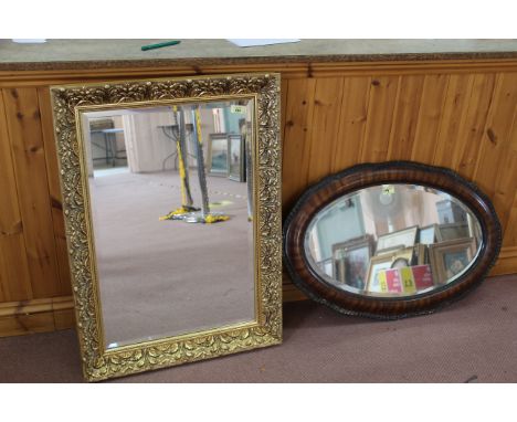 A gilt framed bevelled edge mirror plus an Edwardian oval bevel edge mirror with faux walnut finish