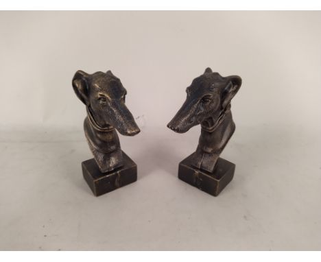 A pair of cast metal greyhound head door stops, a 19th Century oak framed print of Falmouth, three antique oak carvings, a pa