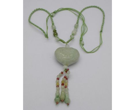 A Chinese carved jade heart shaped pendant
