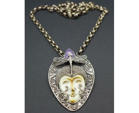 A silver pendant set with a purple jade with silver chain