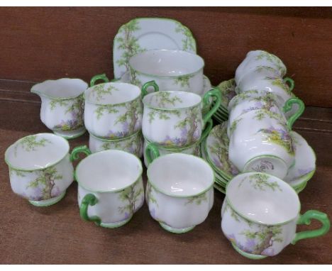 A Royal Albert Greenwood Tree tea service comprising twelve cups and saucers, five cups a/f, twelve sandwich plates, a/f, mil