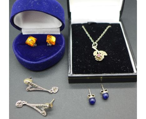 A silver chain with ruby pendant, a pair of silver and amber earrings and two other pairs of silver earrings