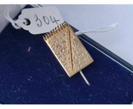 A boxed 9ct designer stick pin in the form of a note pad and pen - 3.8 gms inc 