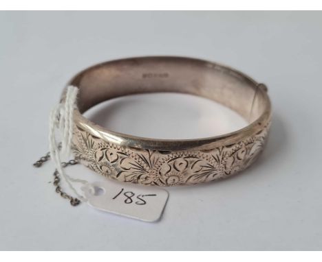 A hinged silver embossed bangle