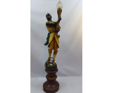 A large Blackamoor lamp modelled as a figure holding aloft a torch, H 178cm 