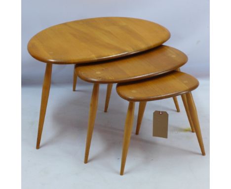An Ercol nest of three tables of pebble form raised on spindle legs, H 40 x W 65 x D 45cm 