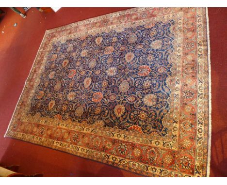 An extremely fine north east Persian Meshad carpet with all over repeating spandrels on a sapphire field guarded by a multi s