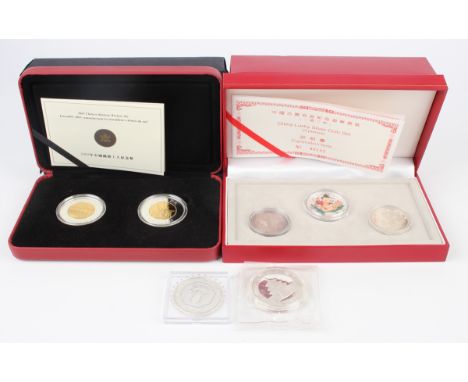 A small group of Chinese and South-east Asian silver commemorative coins, including a China Lucky Silver three-coin set, case