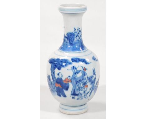 A Chinese porcelain bottle vase, of small proportion, the inverted cylindrical trumpet stem raised above a shouldered body, d