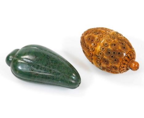 A heavily carved tribal nut kernel box, with screw opening to the centre and orb finial, 8cm high, and a polished spinach jad