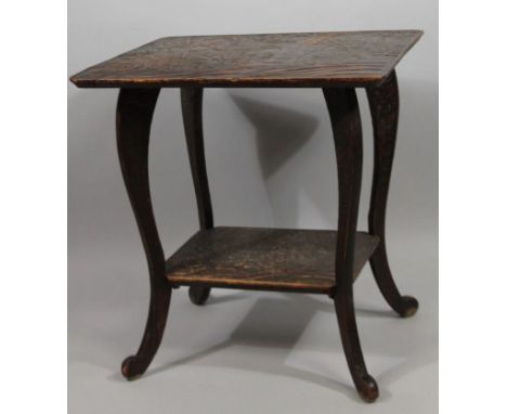 A late 19thC side table, heavily carved with oriental scrolls and flowerheads, the rounded top on an inverted scroll supports