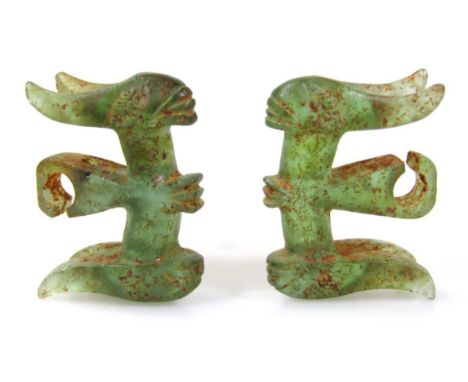 A pair of jade earrings, of shaped outline, with traces of original decoration, each with teardrop centres, probably 19thC.