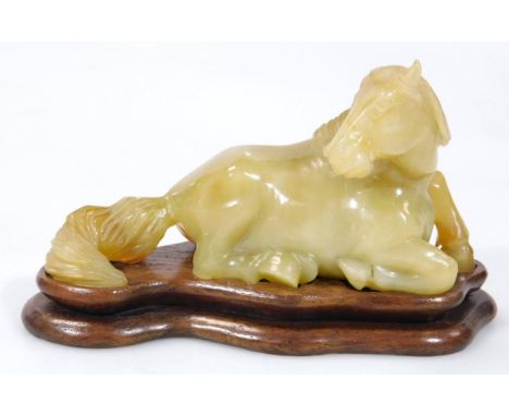 A 20thC Chinese jade figure, of a seated horse, 8cm long.