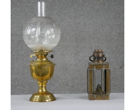 Two brass lamps. Including a Victorian brass oil carriage lamp along with a Duplex brass oil lamp with etched globe shade and