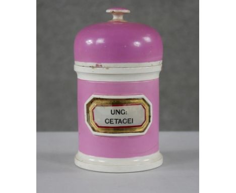 A 19th century York Glass Company, England pink ceramic lidded apothecary jar with gilded glass label. Makers stamp to the ba