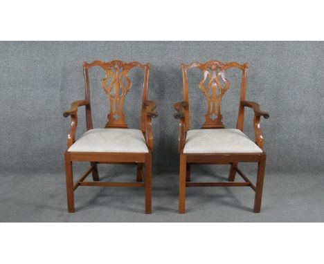 A pair of mahogany Chippendale style open armchairs with drop in seats on square stretchered supports. 