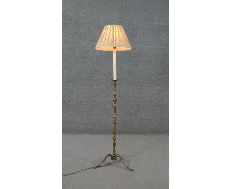 A vintage brass candle stick design tripod standard lamp with cream silk shade. H.138 W.40cm 