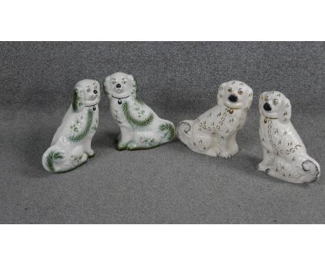 Two pairs of Staffordshire style ceramic spaniels. One pair with Blakeney stamp to bases. H.21 W.15cm 