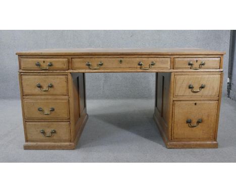 A C.1900 light oak three section pedestal desk with brass swan neck handles on platform base. H.76 W.152 D.75cm 