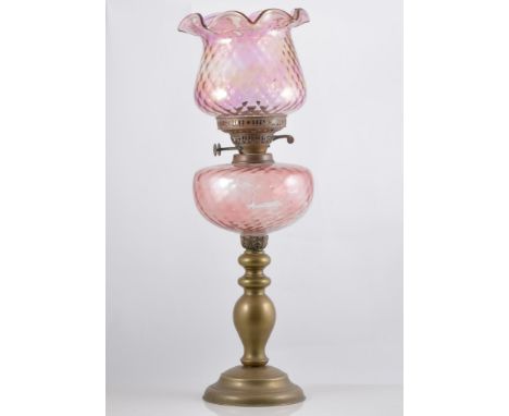 Brass oil lamp, pink tinted moulded reservoir, shade, height overall 59cm.