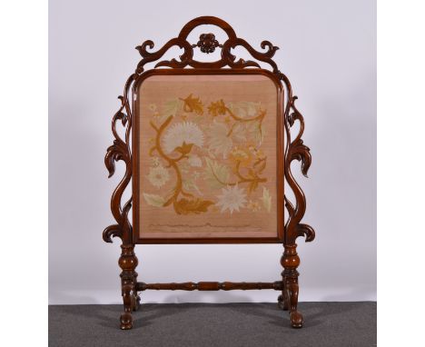 Victorian rosewood framed fire screen, carved and scrolled surround, the legs joined by a turned rail, inset needlework panel