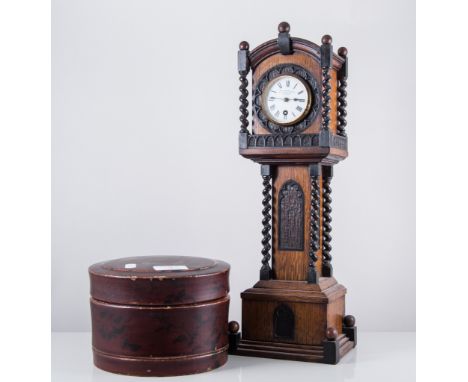 Novelty table clock, designed as an oak longcase clock, gothic revival style, circular enamel dial with Roman numerals, signe