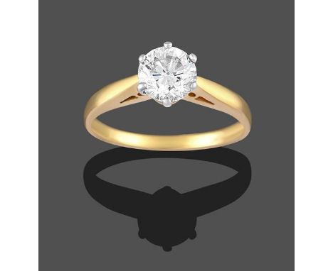 A Diamond Solitaire Ring, the round brilliant cut diamond in a white claw setting, to a yellow tapered shoulder plain polishe