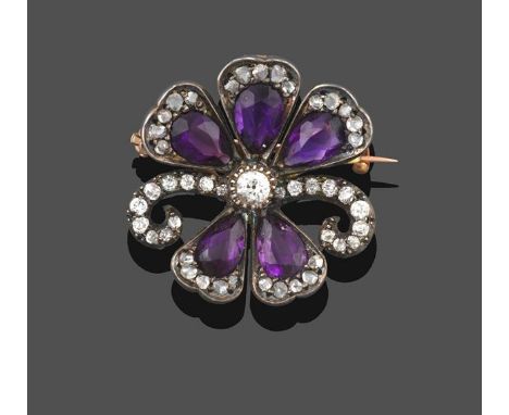 An Edwardian Amethyst and Diamond Brooch/Pendant, in the form of a flower, an old cut diamond centrally with five pear cut am