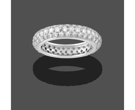 A Diamond Bombé Eternity Ring, three rows of round brilliant cut diamonds in white claw settings, total estimated diamond wei