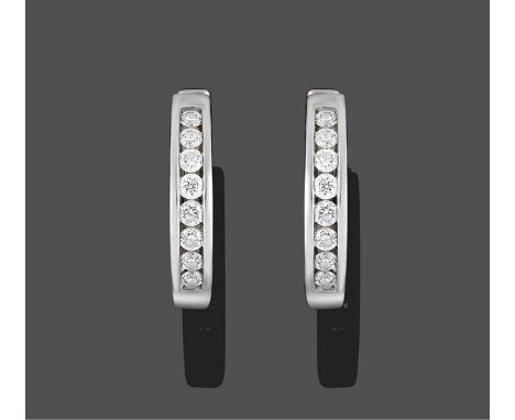 A Pair of 18 Carat White Gold Diamond Cuff Earrings, channel set round brilliant cut diamonds to a hinged plain polished back