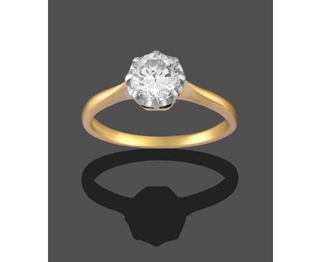 A Diamond Solitaire Ring, the round brilliant cut diamond in a white claw setting, to a yellow tapered shoulder plain polishe