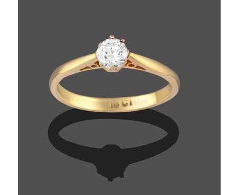 A Diamond Solitaire Ring, the round brilliant cut diamond in a yellow claw setting, to a tapered shoulder plain polished shan